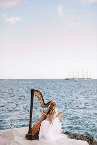 Harpist for Midsummer Night's Eve-themed white welcome party at this Positano wedding weekend in Villa Tre Ville | Photo by Gianni di Natale