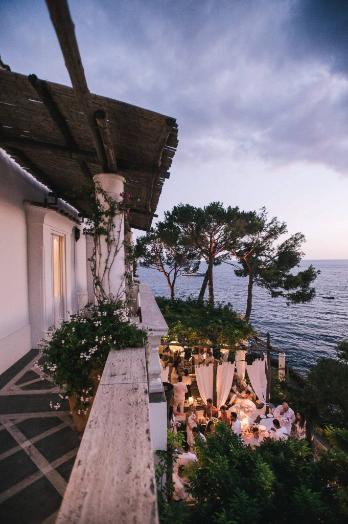 Nighttime at Midsummer Night's Eve-themed white welcome party at this Positano wedding weekend in Villa Tre Ville | Photo by Gianni di Natale