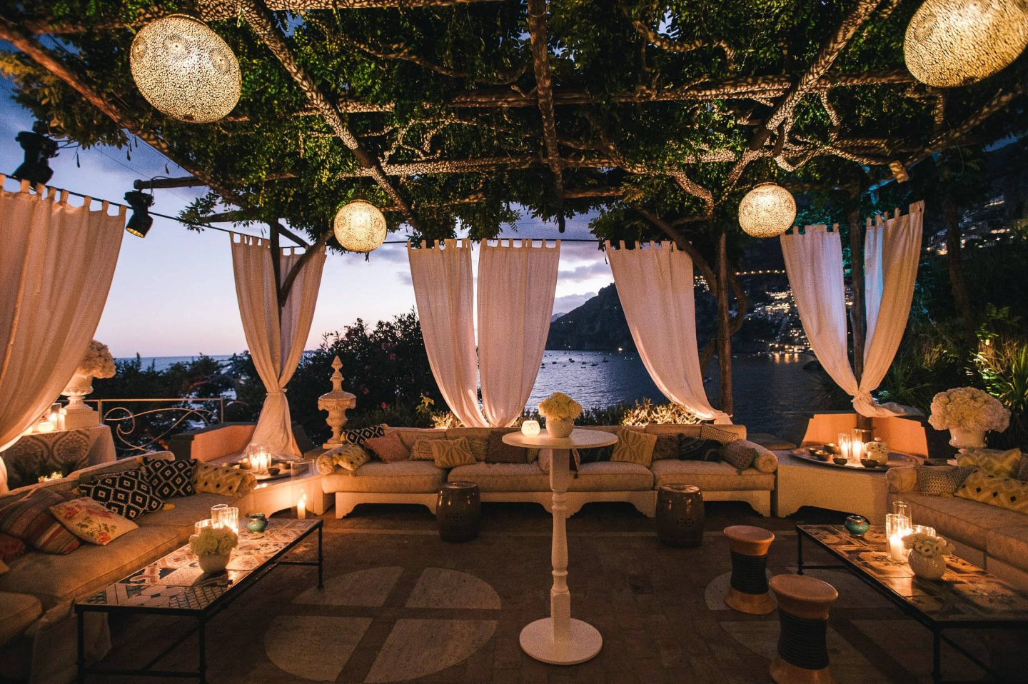 Outdoor lounge at night at the Midsummer Night's Eve-themed white welcome party at this Positano wedding weekend in Villa Tre Ville | Photo by Gianni di Natale