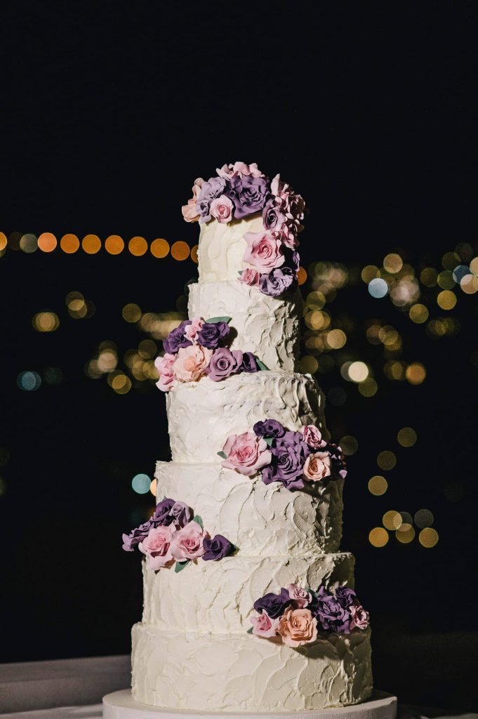 6-tier wedding cake with purple flower design at this Positano wedding weekend in Villa Tre Ville | Photo by Gianni di Natale