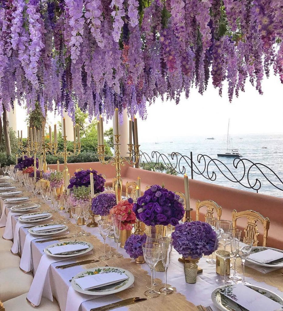 Purple flower decor for reception at this Positano wedding weekend in Villa Tre Ville | Photo by Gianni di Natale