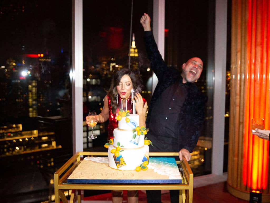 Blowing out the candles at this 40th surprise birthday at the Boom Boom Room in NYC | Photo by Luis Zepeda