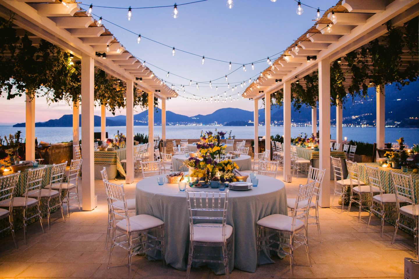 Table decor for a 60s-themed welcome party at this Aman Sveti Stefan Montenegro destination wedding weekend | Photo by Allan Zepeda