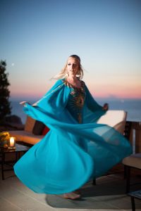 Blue caftan outfit at 60s-themed welcome party at this Aman Sveti Stefan Montenegro destination wedding weekend | Photo by Allan Zepeda