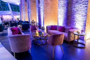 Purple velvet couches in lounge area at this Brooklyn Museum rehearsal dinner in NYC | Photo by Gruber Photo