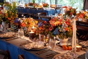 Rustic floral and table decor for the welcome party at this camp-themed wedding weekend at Cedar Lakes Estate in Upstate NY, USA | Photo by Christian Oth Studios