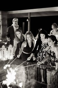 Toasting marshmallows at this rustic welcome party at this camp-themed wedding weekend at Cedar Lakes Estate in Upstate NY, USA | Photo by Christian Oth Studios