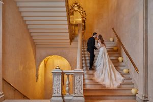 Bride and groom on the staircase at this classic autumn wedding at The Plaza in NYC | Photo by Christian Oth Studio