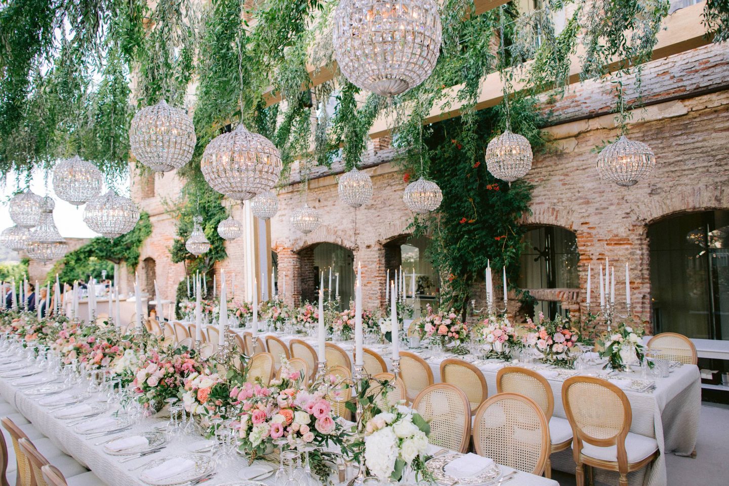 Reception under a garden-inspired pergola beset with taper candles and pink florals at this Istanbul wedding weekend at Four Seasons Bosphorus | Photo by Allan Zepeda