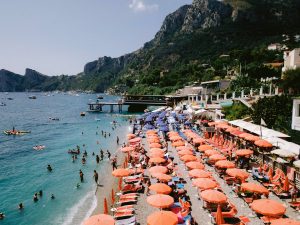 Orange beach umbrellas at this Amalfi Coast wedding weekend held Lo Scoglio | Photo by Allan Zepeda