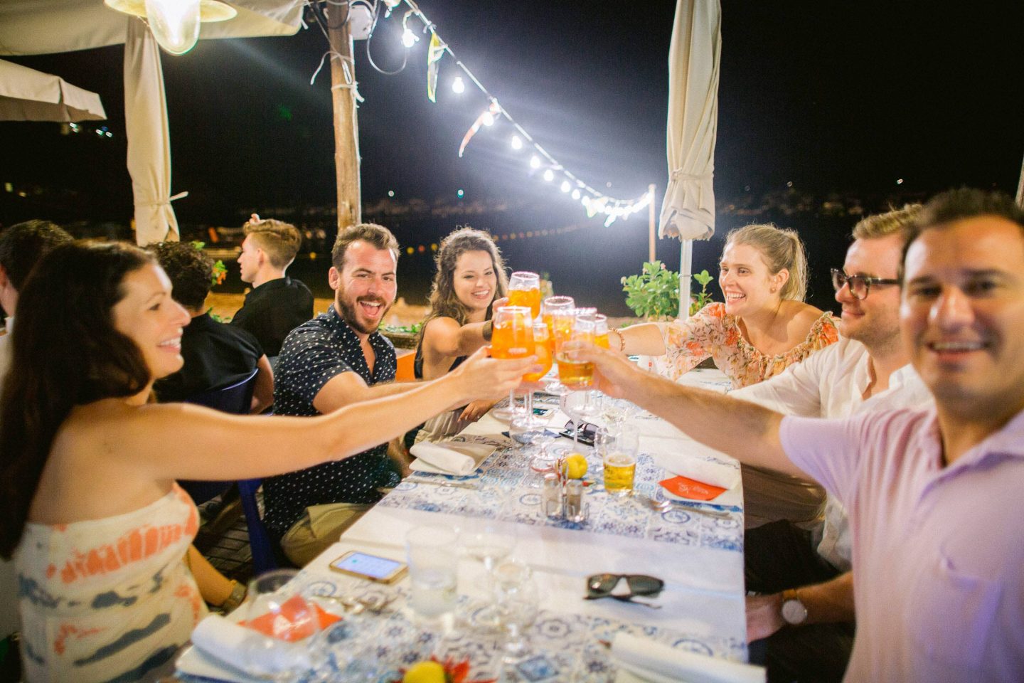 Cheers during the evening pizza party at this Amalfi Coast wedding weekend held Lo Scoglio | Photo by Allan Zepeda