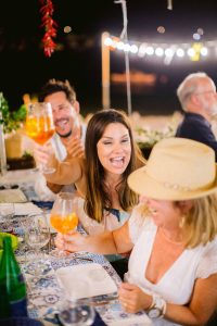 Guests at evening pizza party at this Amalfi Coast wedding weekend held Lo Scoglio | Photo by Allan Zepeda