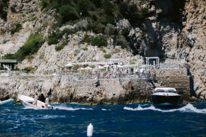 Beach party near Conca del Sogno beach club at this Amalfi Coast wedding weekend held Lo Scoglio | Photo by Allan Zepeda