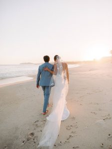 Bride and groom on the beach at sunset at this Los Cabos wedding in Mexico | Photo by Allan Zepeda