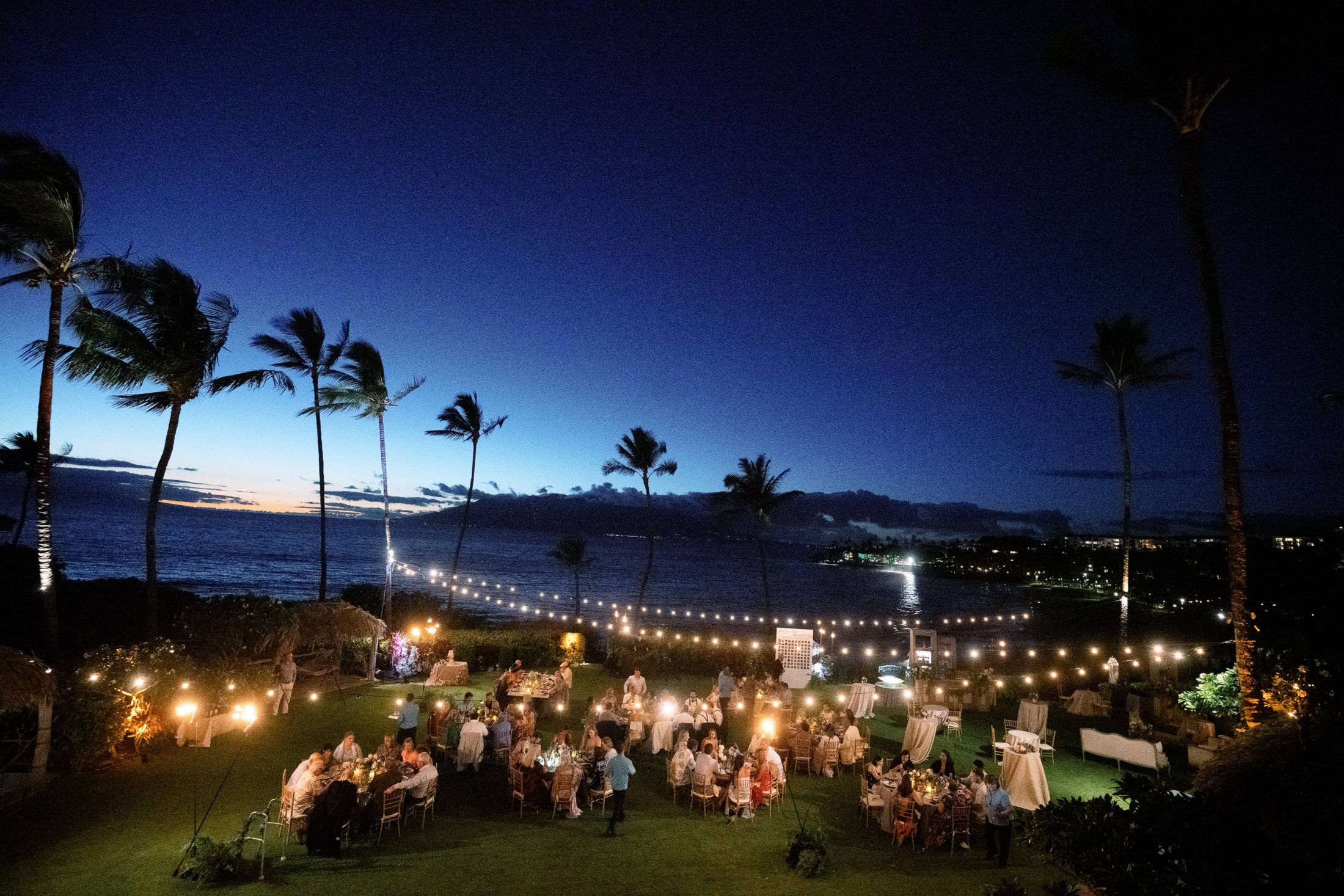 Reception at night under twinkling lights at Maui wedding at Four Seasons Resort Maui in Wailea, Hawaii | Photo by James x Schulze