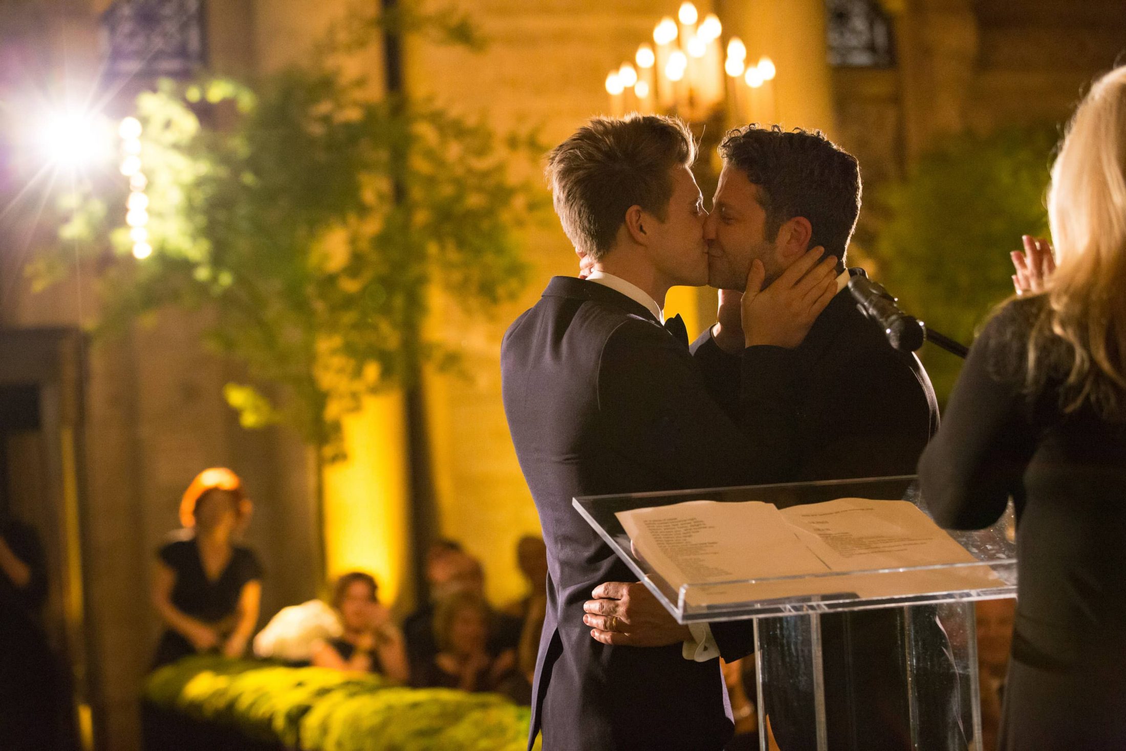 Grooms kiss during ceremony at this New York Public Library wedding | Photo by Genevieve de Manio