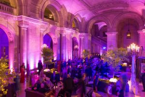 Guests during pink-hued reception at this New York Public Library wedding | Photo by Genevieve de Manio