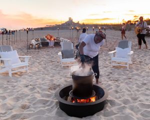 Fire pit at 40th birthday dinner on the beach in Southampton | Photo by Luis Zepeda