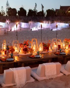 Table set-up at night at 40th birthday dinner on the beach in Southampton | Photo by Luis Zepeda